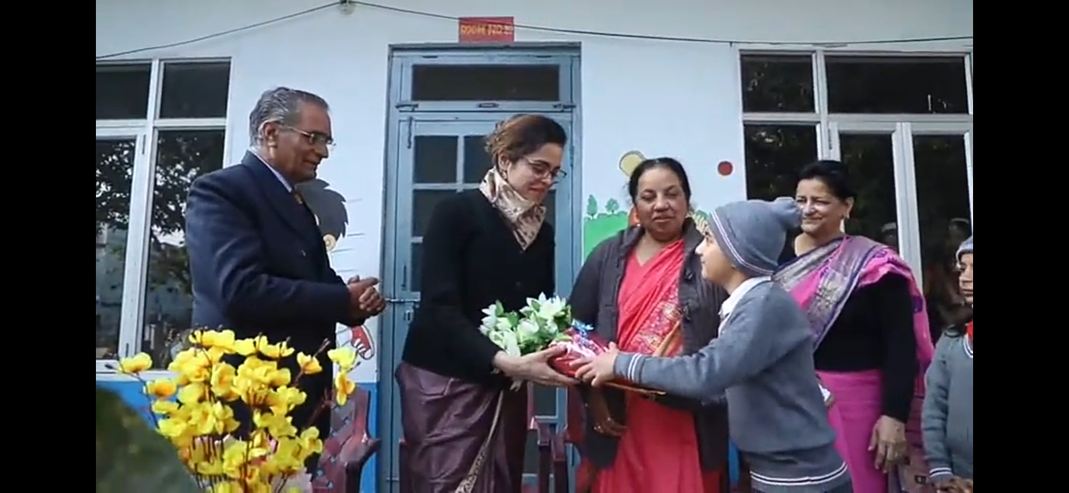A moment in the school courtyard — staff and a student